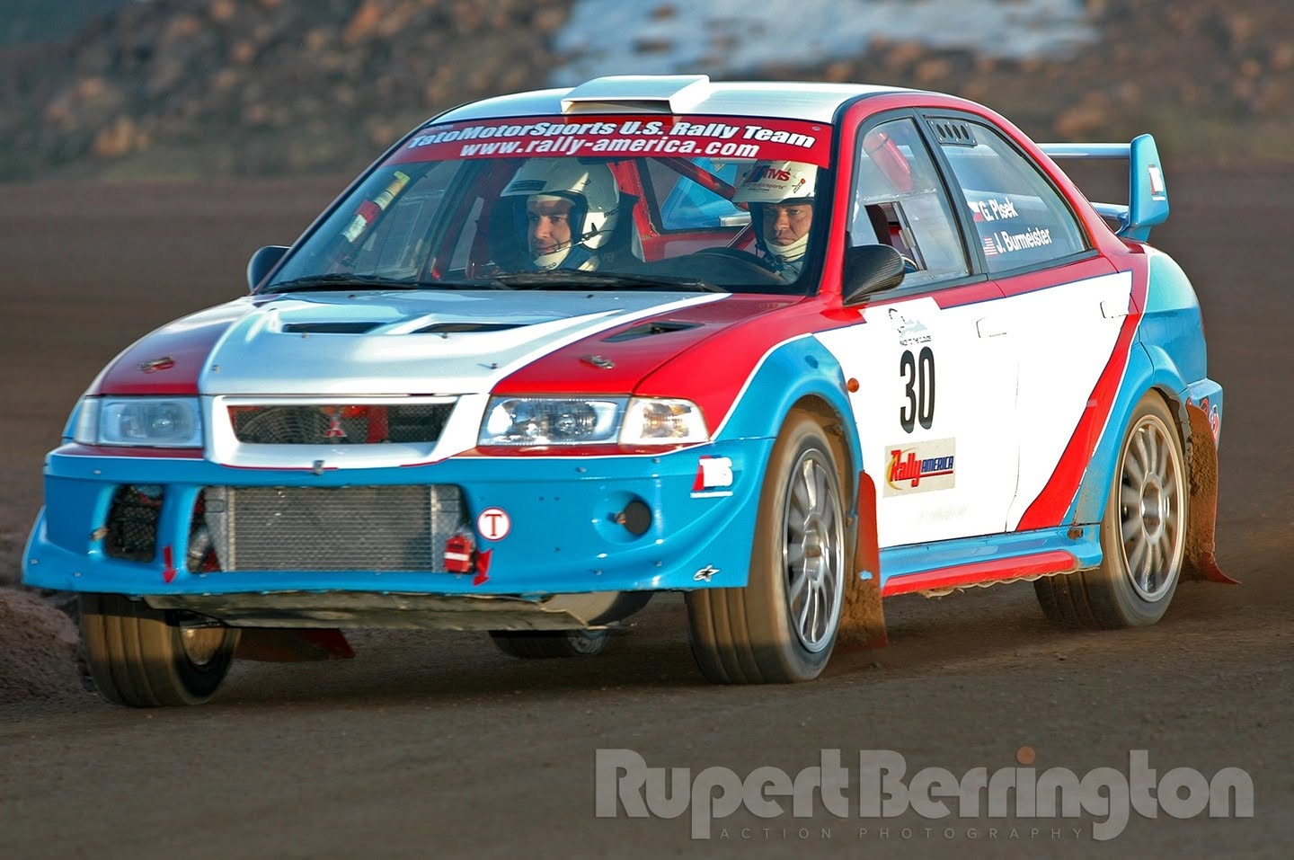 A Mitsubishi Lancer Evolution in an earlier red, white and blue livery, number 30
